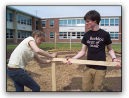 students stringing a cucumber trellis