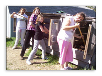 Girls shoveling compost